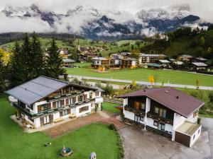 an aerial view of a house with mountains in the background at Appartements Dreimäderlhaus in Maria Alm am Steinernen Meer