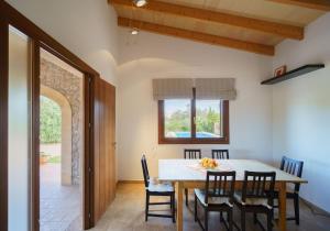 a dining room with a table and chairs at Villa Antonia, Pollença in Pollença