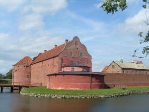 a large brick building next to a body of water at Villa LA in Landskrona