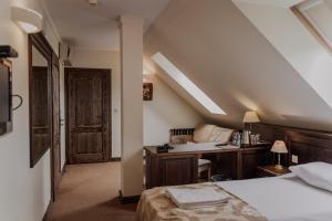 a bedroom with a bed and a desk and a window at Olandia in Kwilcz