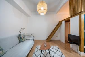 a living room with a couch and a television at Aguirre apartment by People Rentals in Bilbao