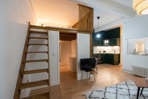 a room with a loft bed and a kitchen at Aguirre apartment by People Rentals in Bilbao