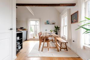 a dining room with a wooden table and chairs at Railway Forge Loft in Haarlem