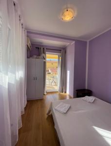 a room with two beds and a door to a patio at Rooms Florie in Becici
