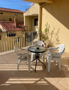 a patio with two chairs and a table on a balcony at Rooms Florie in Becici