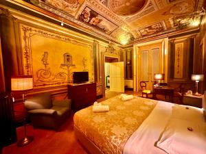 a bedroom with a king sized bed and a chair at Casa Santangelo Suites in Salerno
