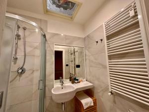 a bathroom with a sink and a shower at Casa Santangelo Suites in Salerno