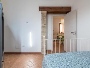 a bedroom with a bed and a hallway with a staircase at Santa Margherita House in Cagliari