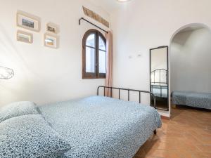 a bedroom with a bed and a mirror at Santa Margherita House in Cagliari