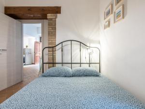a bedroom with a bed with blue pillows on it at Santa Margherita House in Cagliari