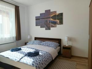 una camera con un letto con due cuscini blu di Strand Vendégház a Poroszló