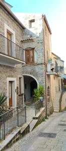a stone building with an entrance to a building with stairs at La Casa di Amelia in Ruviano
