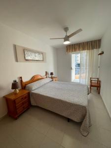 a bedroom with a bed and a dresser and a window at Alpen1 Forner in Peniscola +26 photos