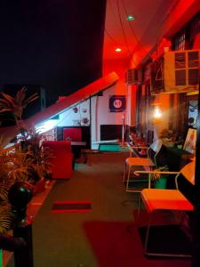 a room with red and blue lights and tables and chairs at New Chandigarh Holiday Home in Chandīgarh