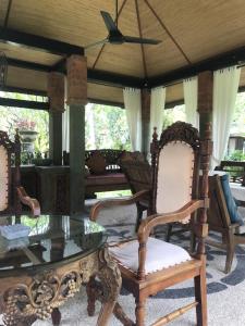 a group of chairs and a glass table in a room at Spacious Private Pool Apartment-Beachside Resort in Candidasa