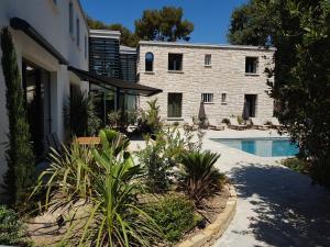 a house with a swimming pool next to a building at HPC Suites - Cassis Centre - Parking Gratuit & Piscine Chauffée in Cassis