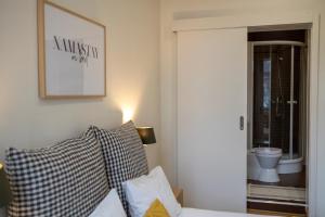 a bedroom with a bed and a picture on the wall at Alfama District by be@home in Lisbon