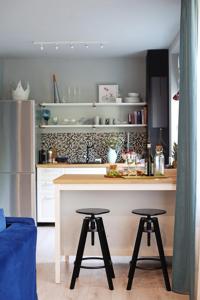 una cucina con bancone e 2 sgabelli da bar di Moft Loft. Lovely, comfy apartment. a Cluj-Napoca