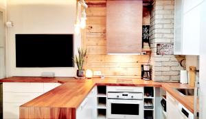 a kitchen with a flat screen tv on a counter at Modern Rustic Stay in Tampere