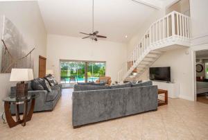 a living room with two couches and a staircase at SWISS 65 - Lake Denise in Clermont