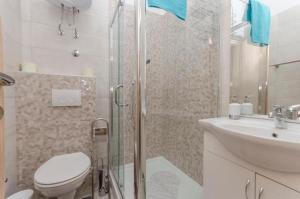 a bathroom with a shower and a toilet and a sink at Apartment Tarle in Vodice +32 photos