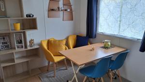 uma mesa e cadeiras num quarto com uma janela em Makado em Castillon-en-Couserans