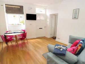 a living room with a couch and a table at "Happy Valley Boutique Accomodation" Hotel Quality, Offering Free Parking in Hebden Bridge