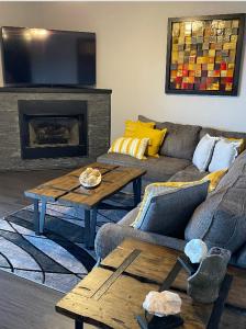 a living room with a couch and a fireplace at Brooklynn's Bay, Elegant Lakefront Condo Retreat in Hot Springs