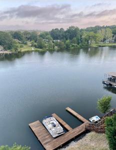 an aerial view of a lake with a dock and boats at Brooklynn's Bay, Elegant Lakefront Condo Retreat in Hot Springs