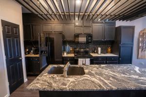 a kitchen with a sink and a counter top at Brooklynn's Bay, Elegant Lakefront Condo Retreat in Hot Springs