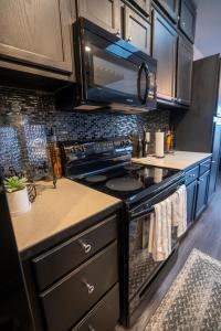 a kitchen with a stove and a microwave at Brooklynn's Bay, Elegant Lakefront Condo Retreat in Hot Springs