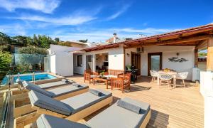 a house with a deck and a swimming pool at Villa Carolina Private Pool in Agios Nikolaos