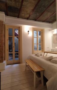 a bedroom with two beds and a table at Filopapou Pearl on Acropolis Hill in Athens