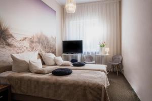 a bedroom with a bed with two pillows on it at Willa Jelitkowska in Gdańsk