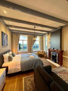 a bedroom with a large bed and a fireplace at De Stadshoeve in Medemblik