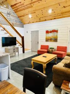 a living room with a couch and a table at Knotty Squirrel Cabins in Mountain View