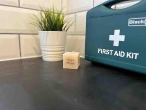 a box of first aid kit next to a plant at Ivory House, central modern town house in Leamington Spa