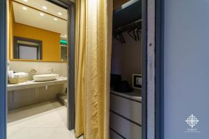 W łazience znajduje się umywalka i lustro. w obiekcie Matteotti Luxury Residence w Syrakuzach