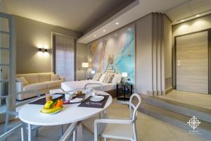 a living room with a white table and chairs at Matteotti Luxury Residence in Siracusa