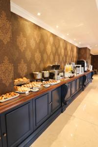 a buffet line with many plates of food on it at Hotel Daara in Gramado