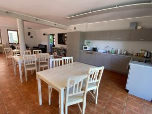 a kitchen and dining room with a table and chairs at Willa Mare in Dębki