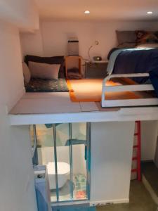 a small room with a bunk bed and a room with a bed at Budget studette without WIFI, 5 min from Paris in Pantin