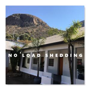 a building with a sign that reads no load shedding at Lake Motel in Hartbeespoort