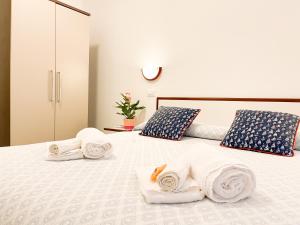 a bedroom with a bed with towels on it at Soggiorno Marina in Varazze