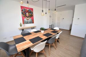 a dining room with a large wooden table and chairs at 5056 Apartamento Nuba Javea in Jávea