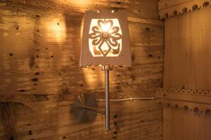 a lamp in a room with a wooden wall at Wooden Tatra House in Zakopane