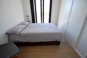 a small bedroom with a bed and a window at 5056 Apartamento Nuba Javea in Jávea +30 photos