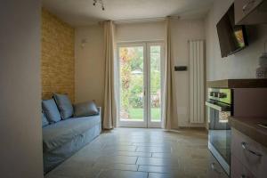 a living room with a couch and a sliding glass door at Residenza Aurora in Ostuni