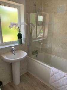 a bathroom with a sink and a shower and a tub and a sink at Renovated home, fab location, garden, pet friendly and parking in Chester