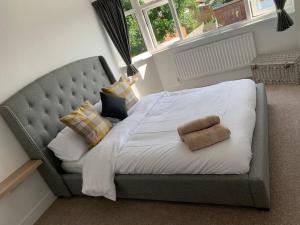 łóżko w sypialni z dużym łóżkiem z białą pościelą w obiekcie Renovated home, fab location, garden, pet friendly and parking w mieście Chester